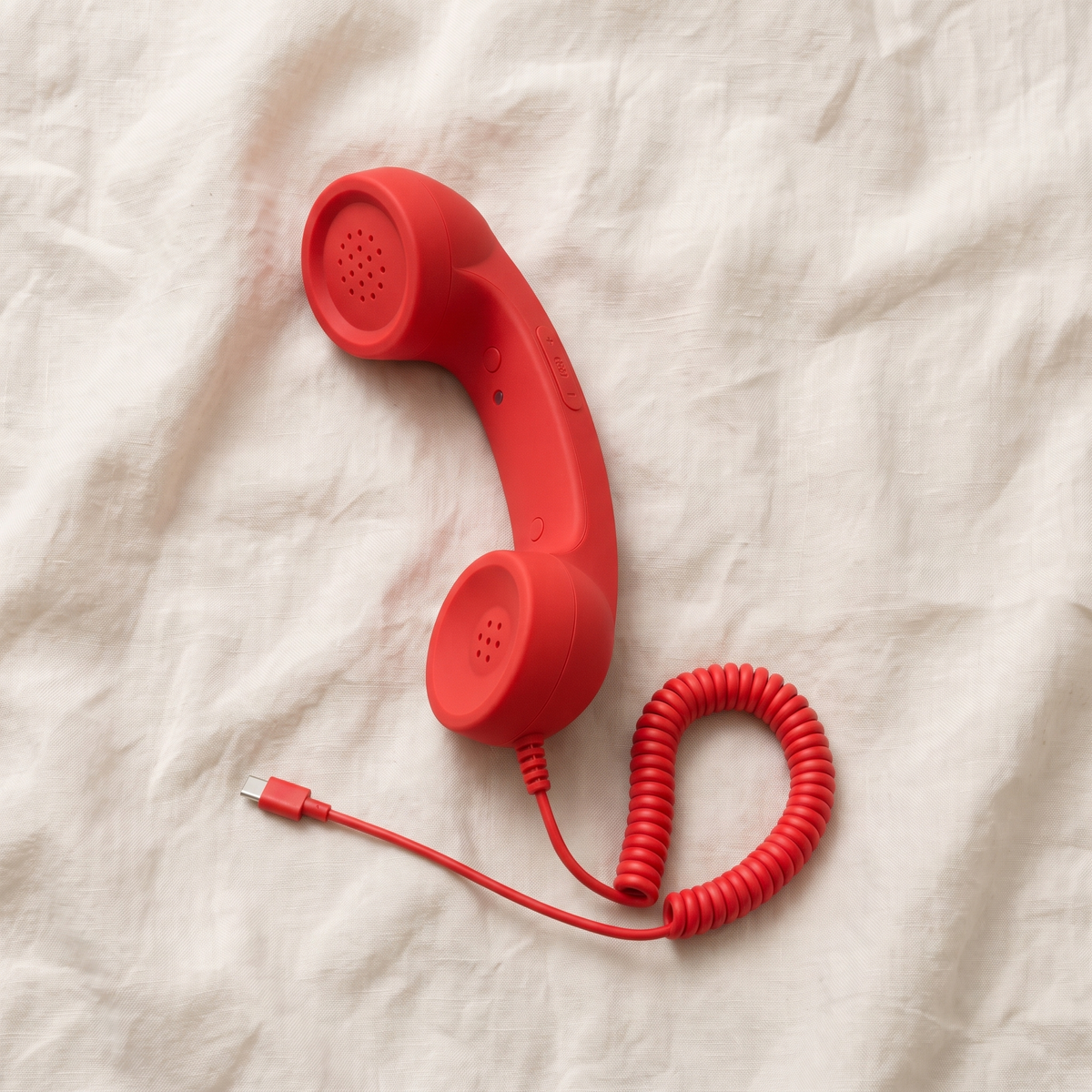 The Ring Me handset photographed from above on white linen